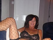 Sexy brunette wife shows off her big tits and fishnet stockings