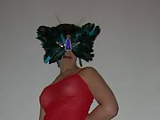 Beautiful brunette in tit bearing sheer lingerie and sexy feather mask
