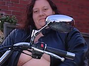 Biker babe shows off her massive tits on her bike