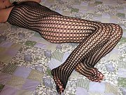 Asian milf in fishnet body suit shows off her sexy body