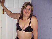 Naughty wife poses in black lingerie in the bedroom