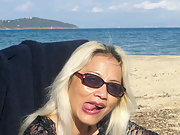 Blonde mature showing off her sexy tits and pussy on public beach