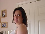Brunette milf takes off her bra and shows her big tits