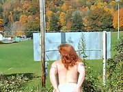 Fucking redhead whore poses and masturbates nude in the outdoors