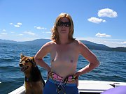 Blonde wife goes topless outside in a boat on the lake
