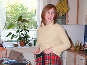 Polish housewife Adela stripping her clothes at the kitchen