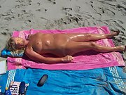 Blonde wife soaks up the sun as she sunbaths naked
