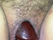 Wife takes a big black dildo deep into her pussy