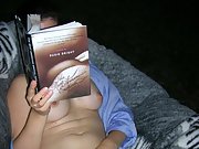 Brunette wife teases her hairy pussy while reading a book