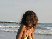 Malika wearing a yellow bikini at the beach gets naked