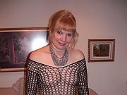 Nude in the bedroom wearing a sexy black fishnet outfit
