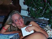 Blonde wife poses naked in front of the christmas tree