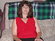 Brunette milf shows off her big tits on the couch