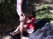Mature milf enjoys in giving her man head in the nature on picnic